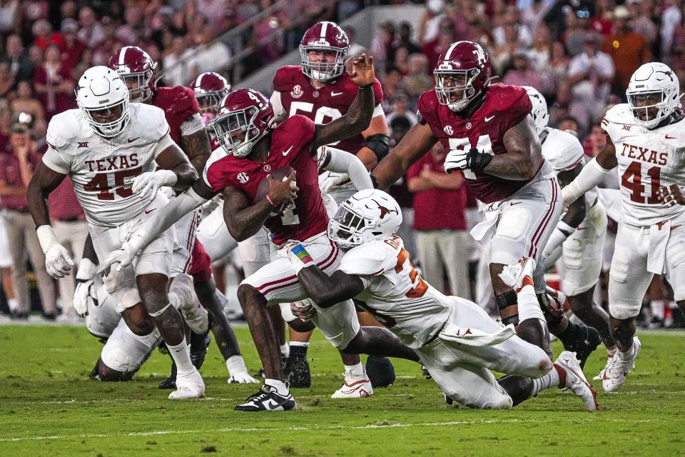 Alabama quarterback Jalen Milroe (4) is sacked by Texas linebacker David Gbenda (3) during the game at Bryant-Denny Stadium on Saturday, Sep. 9, 2023 in Tuscaloosa,