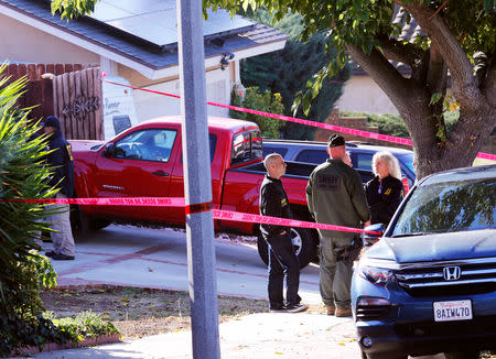 Police and FBI officers wait outside the home of the suspect in a shooting incident at a Thousand Oaks bar, in Newbury Park, California, U.S. November 8, 2018. REUTERS/Mike Blake