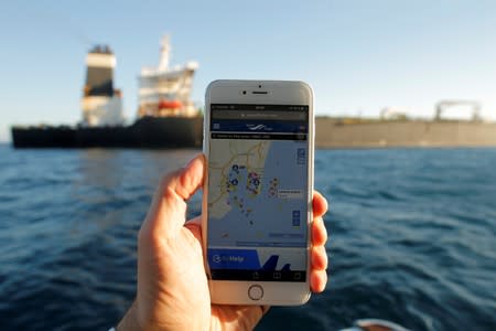 The position of the Iranian oil tanker Adrian Darya 1, formerly named Grace 1, is seen on a mobile phone as it sits anchored after the Supreme Court of the British territory lifted its detention order, in the Strait of Gibraltar