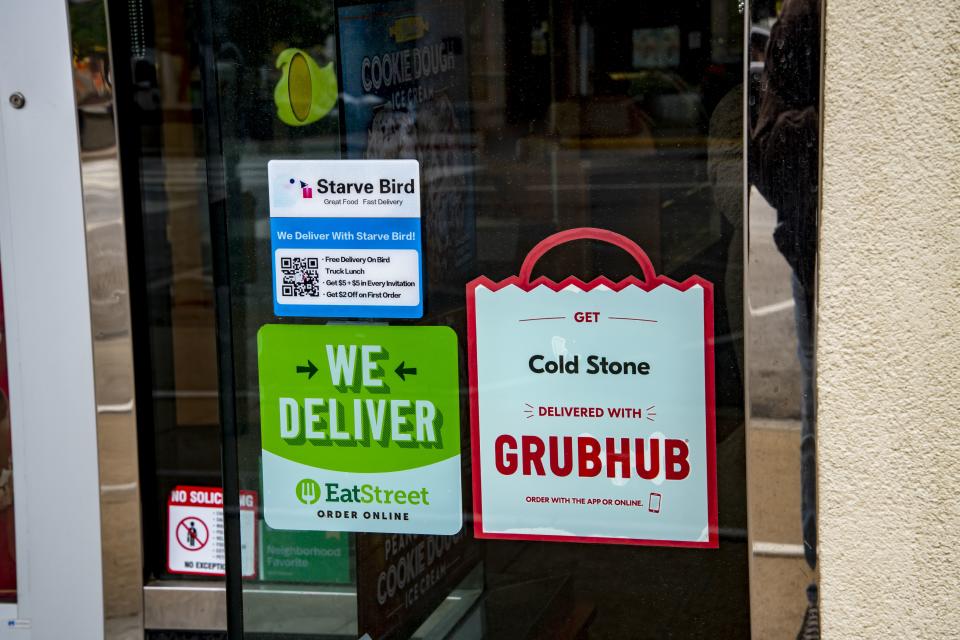 Lawrence, Kansas, Variety of food delivery services advertised in restaurant store window. (Photo by: Michael Siluk/UCG/Universal Images Group via Getty Images)