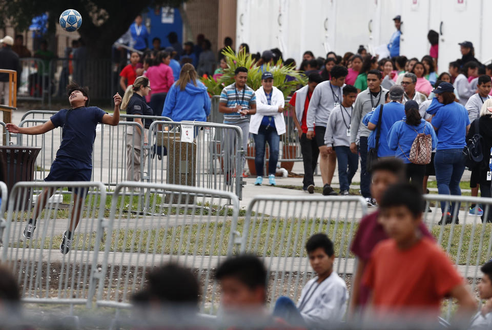 A migrant teen plays soccer as others gather at the Homestead Temporary Shelter for Unaccompanied Children in Homestead, Florida, in December. (Photo: Brynn Anderson/ASSOCIATED PRESS)