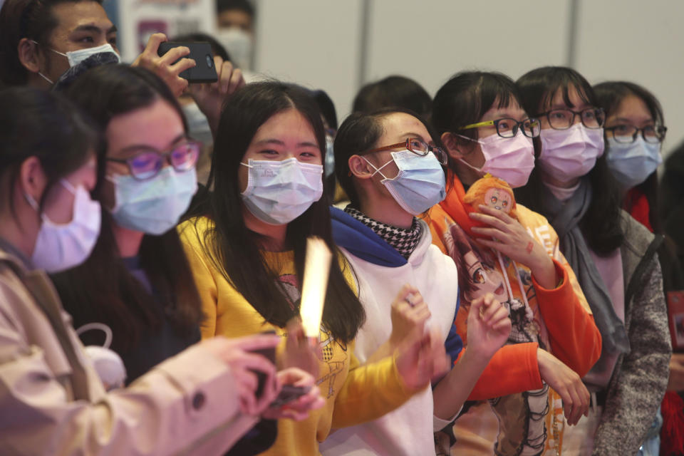 Visitors wear face masks at the Comic Exhibition in Taipei, Taiwan, Sunday, Feb. 2, 2020. A viral outbreak that began in China has infected more than 11,900 people globally. (AP Photo/Chiang Ying-ying)