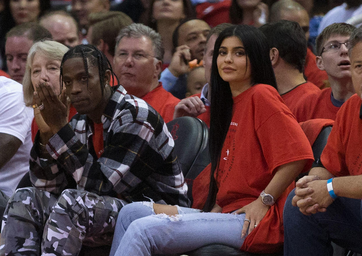 Kylie Jenner's rumored new beau, Travis Scott, here with her at a basketball game in April, is being sued for not paying a (big) bill.