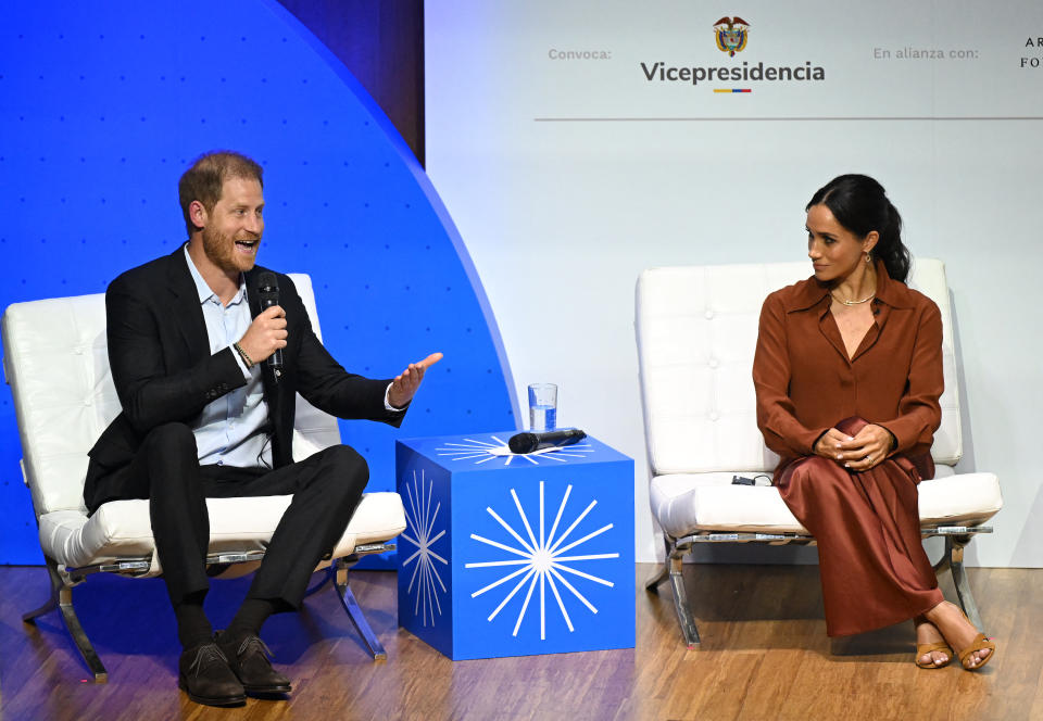 Britain's Prince Harry, Duke of Sussex, speaks during the 'Responsible Digital Future' forum as his wife Meghan Markle listens in Bogota on August 15, 2024. Prince Harry and his wife, American actress Meghan Markle, arrived in Colombia at the invitation of Colombia's vice-President Francia Marquez, with whom they will attend various meetings with women and young people to reject discrimination and cyberbullying. (Photo by RAUL ARBOLEDA / AFP) (Photo by RAUL ARBOLEDA/AFP via Getty Images)