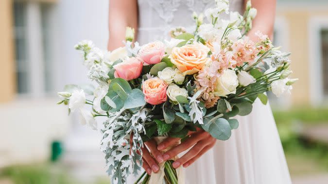 Beautiful wedding bouquet in hands of the bride.