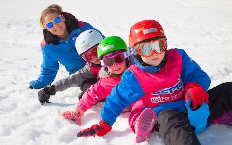 Esprit Ski nanny with three children in snow - Credit: Esprit Ski/Don Wales