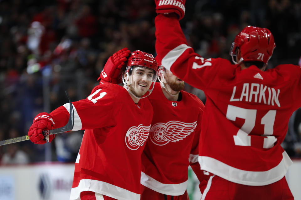 Detroit Red Wings right wing Filip Zadina (11) celebrates his goal with Filip Hronek (17) and Dylan Larkin (71) in the second period of an NHL hockey game against the Winnipeg Jets, Thursday, Dec. 12, 2019, in Detroit. (AP Photo/Paul Sancya)