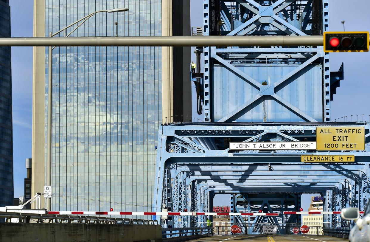 The bridge tender takes in the view of stopped traffic from the catwalk on one of the towers of the Main Street bridge while the bridge was up to allow a tugboat to pass through this week. [Bob Self/Florida Times-Union]