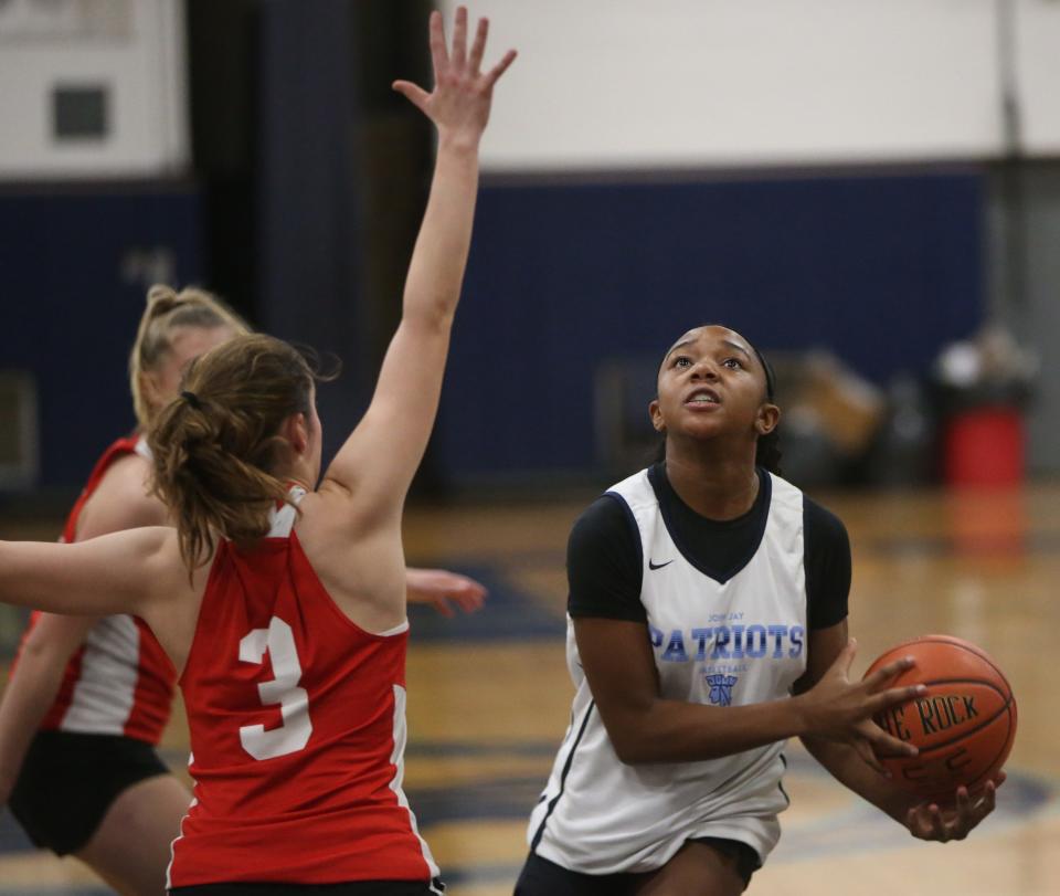 John Jay's Laila Moore-Terry goes for a layup against Red Hook's Emmy Nelson-Madore during Thursday's scrimmage on November 30, 2023.
