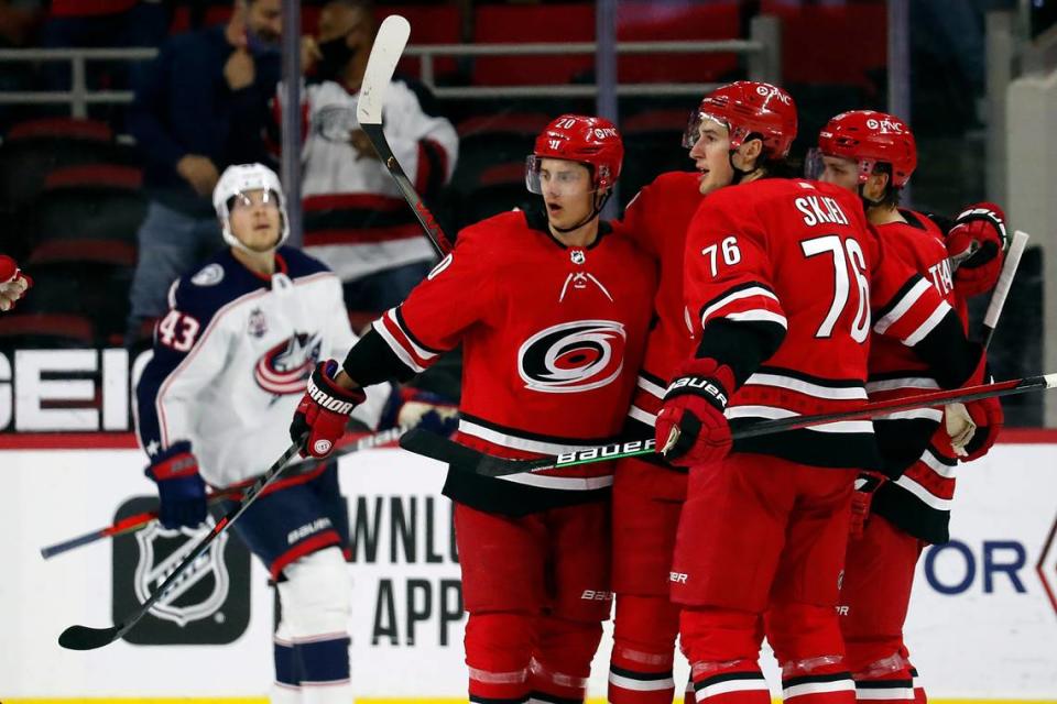 The Carolina Hurricanes celebrate a goal by Teuvo Teravainen (86) against the Columbus Blue Jackets during the first period of an NHL hockey game in Raleigh, N.C., Saturday, May 1, 2021. (AP Photo/Karl B DeBlaker)