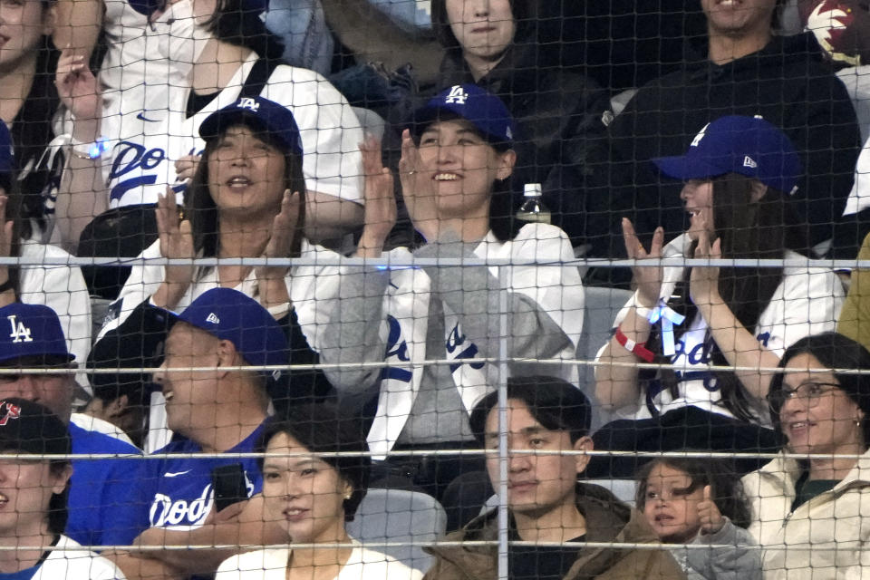 Mamiko Tanaka, center, wife of Los Angeles Dodgers' Shohei Ohtani watches during an opening day baseball game between the San Diego Padres and the Dodgers at the Gocheok Sky Dome in Seoul, South Korea Wednesday, March 20, 2024, in Seoul, South Korea. (AP Photo/Ahn Young-joon)
