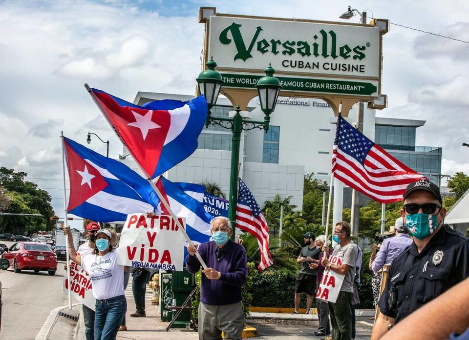 A group of Cuban exiles gather at Versailles Restaurant to support a caravan through the streets of Miami in support of the song ‘Patria y Vida’ on March 6, 2021.