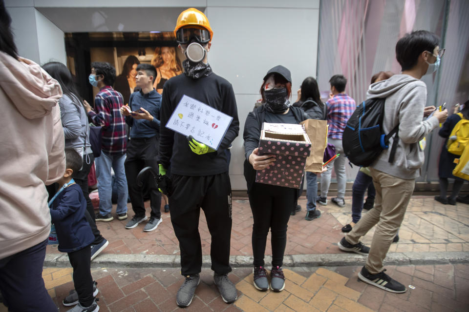 Protesters hold a box to collect Christmas cards for detained and jailed protesters during a rally in Hong Kong, Monday, Dec. 16, 2019. China's premier said Monday that turmoil over amendments to extradition legislation has damaged Hong Kong society on all fronts. (AP Photo/Mark Schiefelbein)