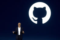 Microsoft CEO Satya Nadella speaks as the logo of Github, a subsidiary of Microsoft Corp, is displayed on the screen during an event titled "Microsoft Build: AI Day" in Jakarta, Indonesia, Tuesday, April 30, 2024. Microsoft will invest $1.7 billion over the next four years in new cloud and artificial intelligence infrastructure in Indonesia — the single largest investment in Microsoft's 29-year history in the country — Nadella said Tuesday. (AP Photo/Dita Alangkara)
