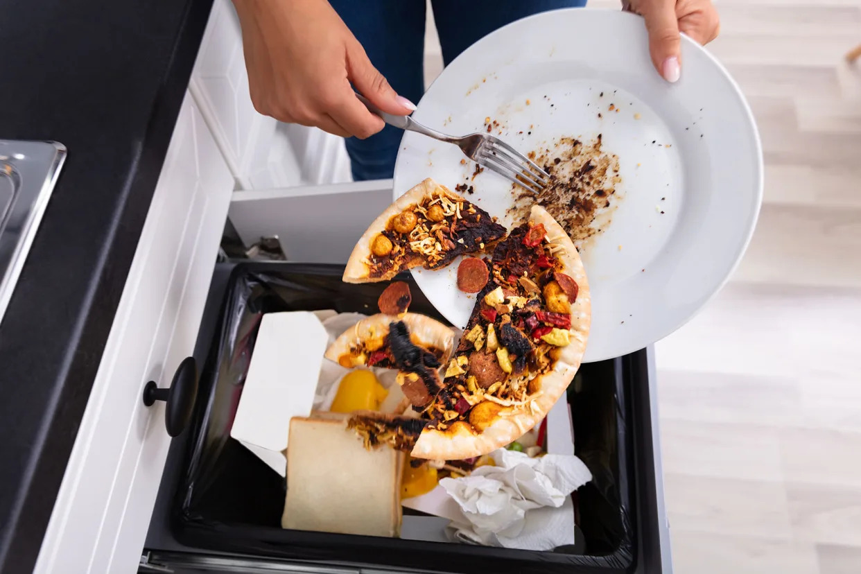 Person Throwing Pizza In Garbage Getty Images/Andrey Popov