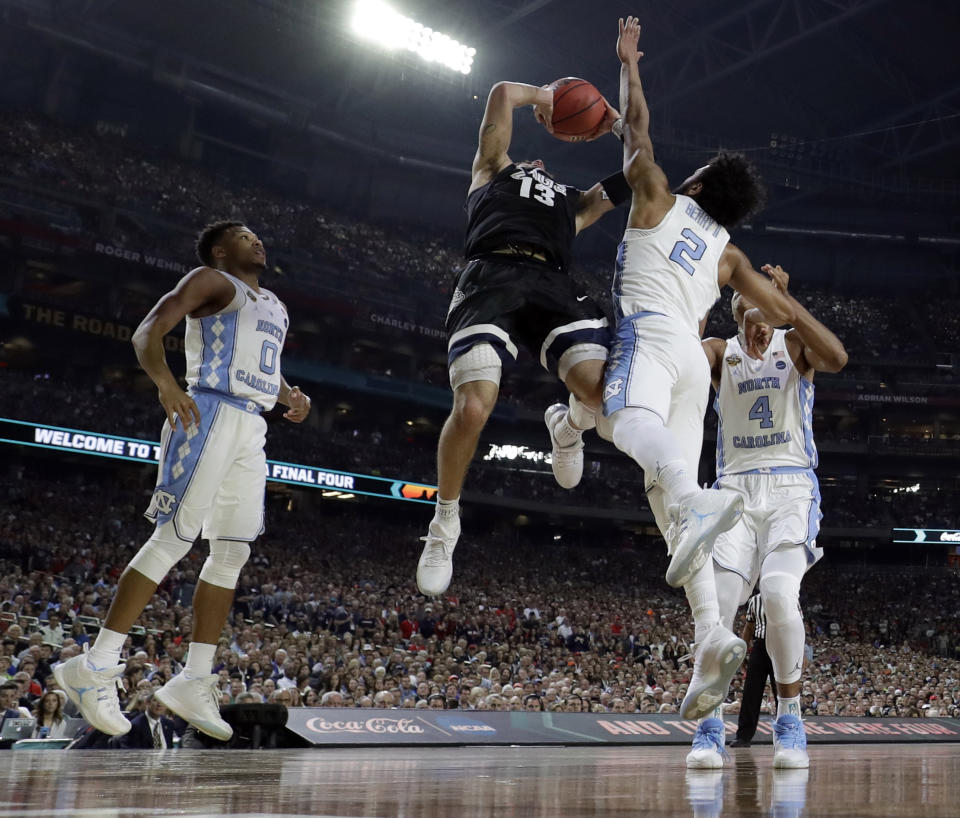 Gonzaga's Josh Perkins (13) takes a shot over North Carolina's Joel Berry II (2) during the first half in the finals of the Final Four NCAA college basketball tournament, Monday, April 3, 2017, in Glendale, Ariz. (AP Photo/David J. Phillip)