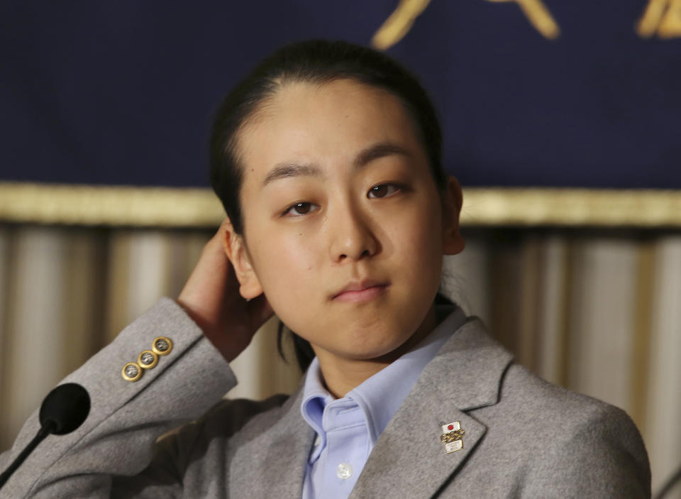 Japanese figure Skater Mao Asada adjusts her hair while listening to a reporter's question during a press conference at the Foreign Correspondents' Club of Japan in Tokyo Tuesday, Feb. 25, 2014 upon returning from Sochi, Russia. Asada says there is a 50-50 chance she will continue her career after an impressive performance in the free skate at the Sochi Olympics. Asada fell on her trademark triple axel to finish a disappointing 16th after the short program in Sochi but came back strong in the free skate, recording a season's best of 142.71 that gave her a total of 198.22 points for sixth place. (AP Photo/Koji Sasahara)