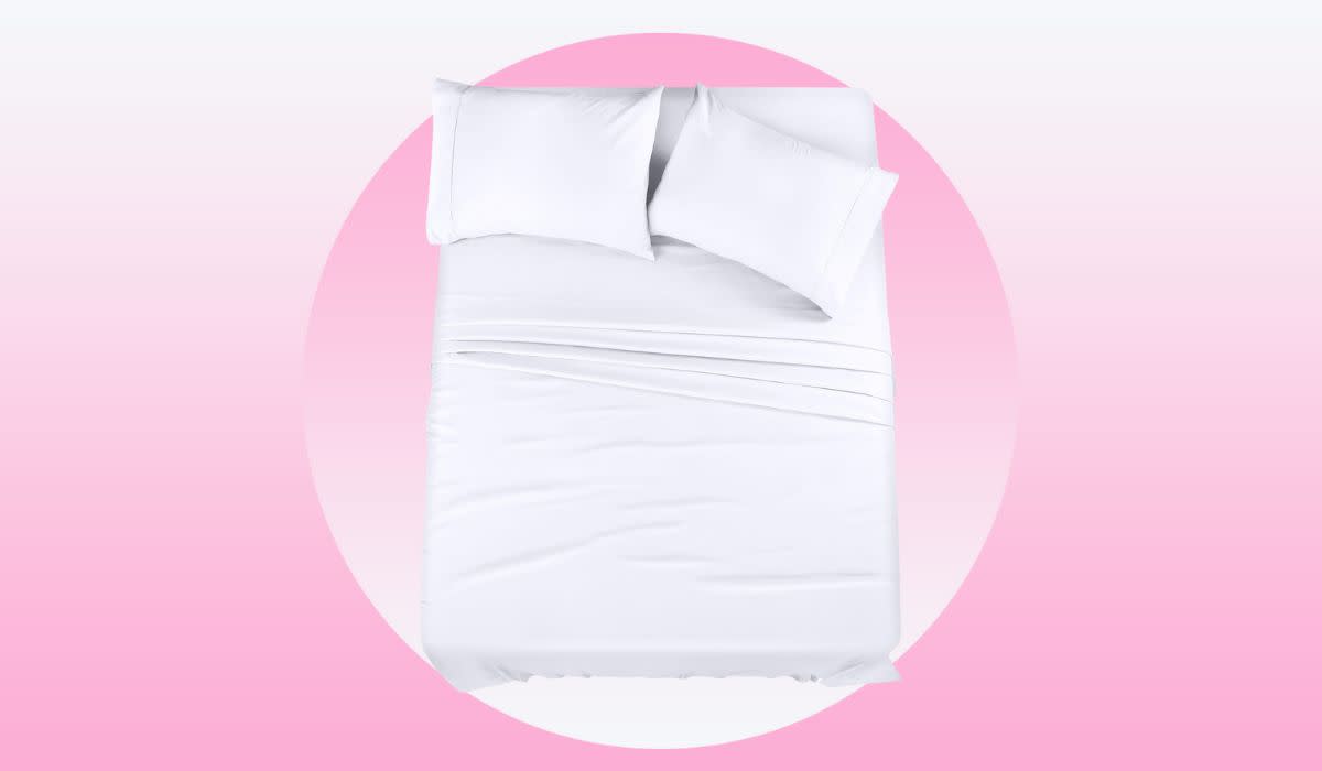 A bed with white sheets and two pillows.