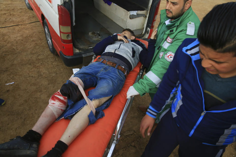 Medics move a wounded protester to a field clinic tent after being shot during a protest near the fence of the Gaza Strip border with Israel, near Beit Lahiya, northern Gaza Strip, Tuesday, Feb. 19, 2019. (AP Photo/Adel Hana)