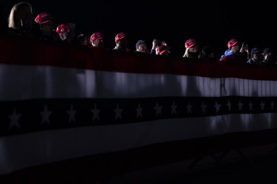 FILE - In this Oct. 24, 2020, file photo supporters of President Donald Trump listen to him speak during a campaign rally at Waukesha County Airport in Waukesha, Wis. (AP Photo/Evan Vucci, File)