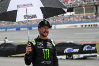 Kurt Busch walks back to garage during a rain delay at a NASCAR Cup Series auto race at Talladega Superspeedway in Talladega, Ala., Sunday, Oct. 13, 2019. (AP Photo/Butch Dill)