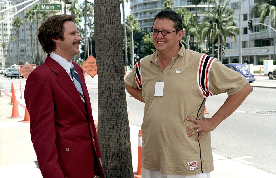 McKay puts his hands on his waist while smiling at Ferrell