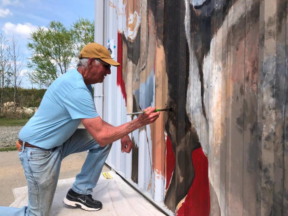 Sculptor Dale Weiler helps muralist Matt Willey create a scene featuring red wolves on a building in the Pocosin Lakes National Wildlife Refuge outside Columbia. Red wolves are an endangered species that live in the wild only in Eastern North Carolina.