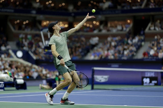 Jannik Sinner throws the ball up to serve at the US Open