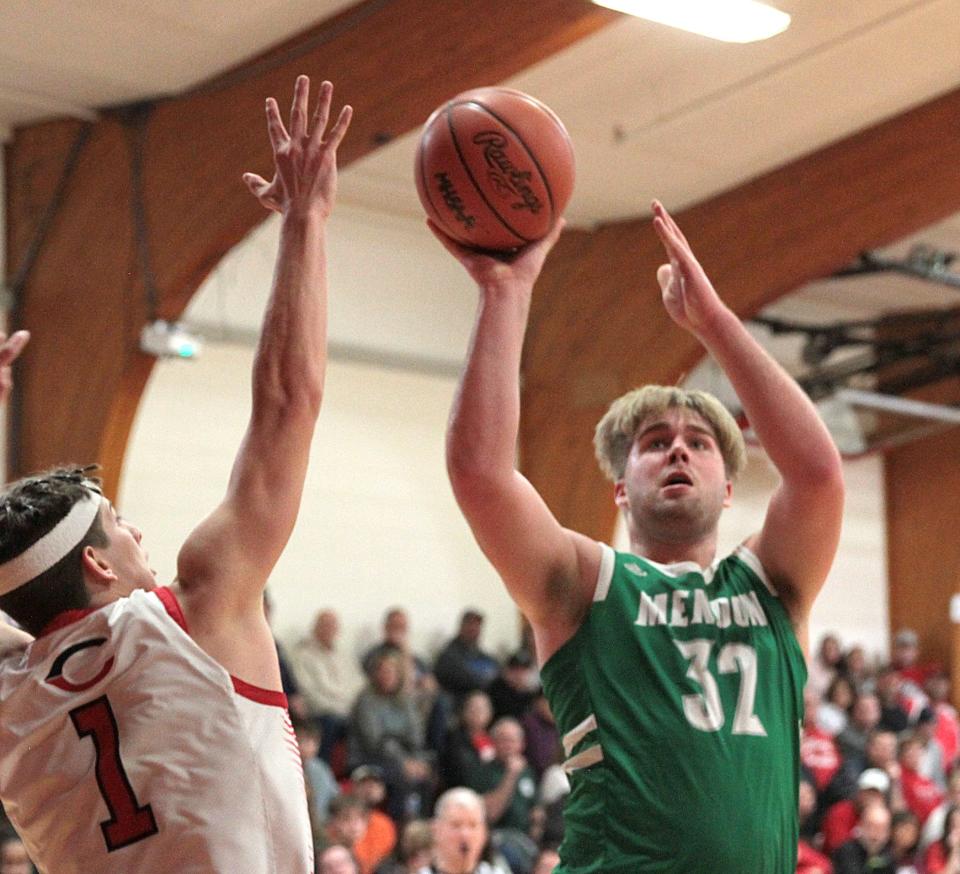 Gabe Haigh scores two points for Mendon against Colon on Friday night.