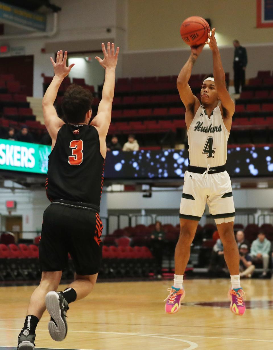 Yorktown's Brandon Montero (4) puts up a shot in front of Mamaroneck's Elijah Friedman (3) during the Slam Dunk Classic at the Westchester County Center in White Plains Jan. 5, 2024.