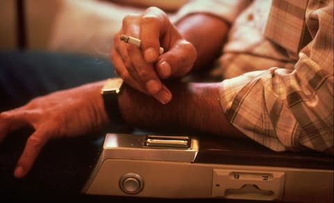 Ashtrays can still be found on planes, long after smoking was banned - Credit: Getty