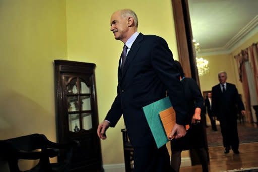 Greek Prime Minister George Papandreou arrives for a meeting at the presidental palace in Athens. The latest turmoil began with Papandreou's shock announcement a week ago that Greece would hold a referendum on the massive EU rescue deal which aims to slash the country's debt by almost a third