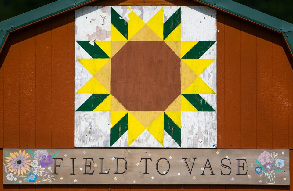 A barn quilt sign on a shed Thursday, June 9, 2022, at Field to Vase U-Pick Flowers in New Carlisle.