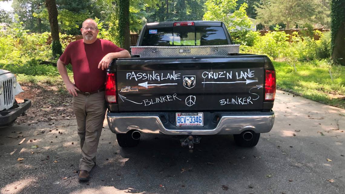 Mike Lindgren, a roadway designer at the N.C. Department of Transportation, stands next to his Dodge Ram. Lindgren’s message about blinkers and passing and ‘cruz’n’ lanes went viral when another NCDOT employee took a photo of it in traffic and posted it online.