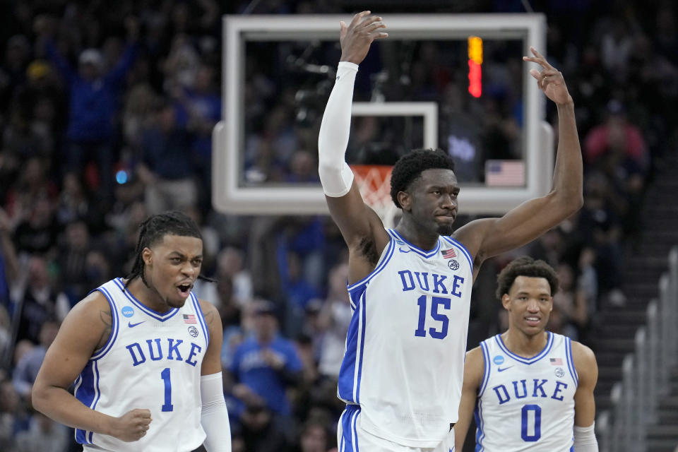 Duke guard Trevor Keels (1) celebrates with center Mark Williams (15) and forward Wendell Moore Jr. (0) during the second half of a college basketball game against Arkansas in the Elite 8 round of the NCAA men's tournament in San Francisco, Saturday, March 26, 2022. (AP Photo/Tony Avelar)