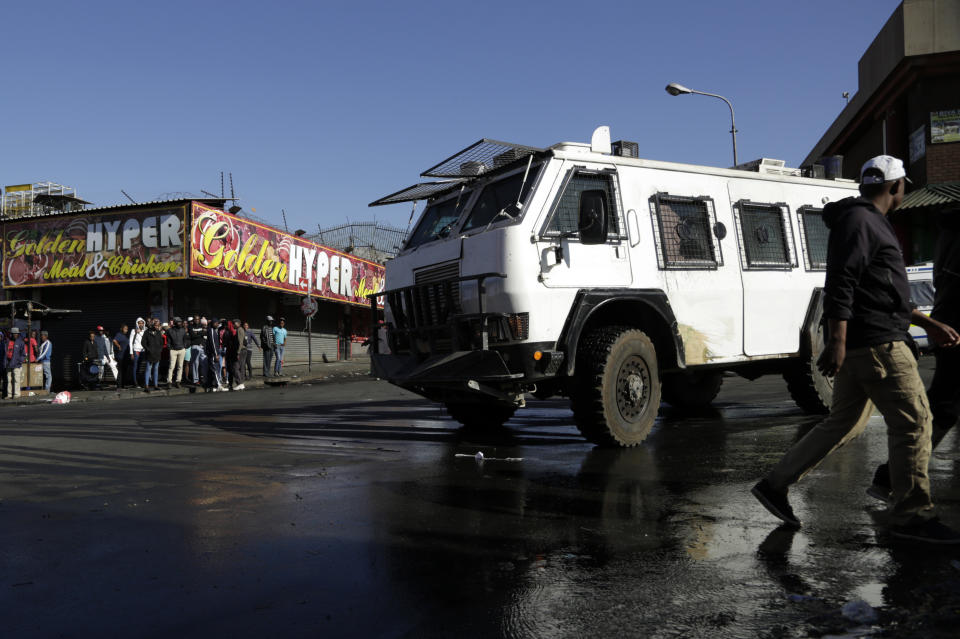 A police truck patrols an area affected by looters from a store in Germiston, east of Johannesburg, South Africa, Tuesday, Sept. 3, 2019. Police had earlier fired rubber bullets as they struggled to stop looters who targeted businesses as unrest broke out in several spots in and around the city. (AP Photo/Themba Hadebe)