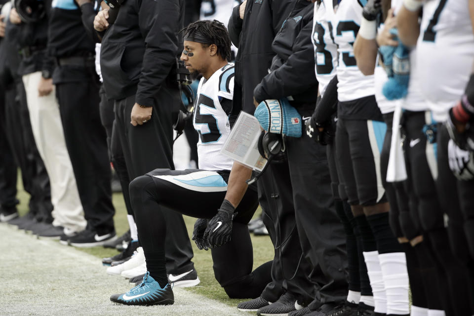 Carolina Panthers strong safety Eric Reid, center, takes a knee during the playing of the national anthem prior to an NFL football game against the Philadelphia Eagles, Sunday, Oct. 21, 2018, in Philadelphia. (AP Photo/Matt Rourke)