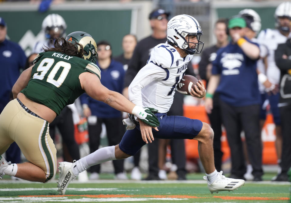 Colorado State defensive lineman Grady Kelly, left, tackles Nevada quarterback AJ Bianco after a short gain in the first half of an NCAA college football game Saturday, Nov. 18, 2023, in Fort Collins, Colo. (AP Photo/David Zalubowski)