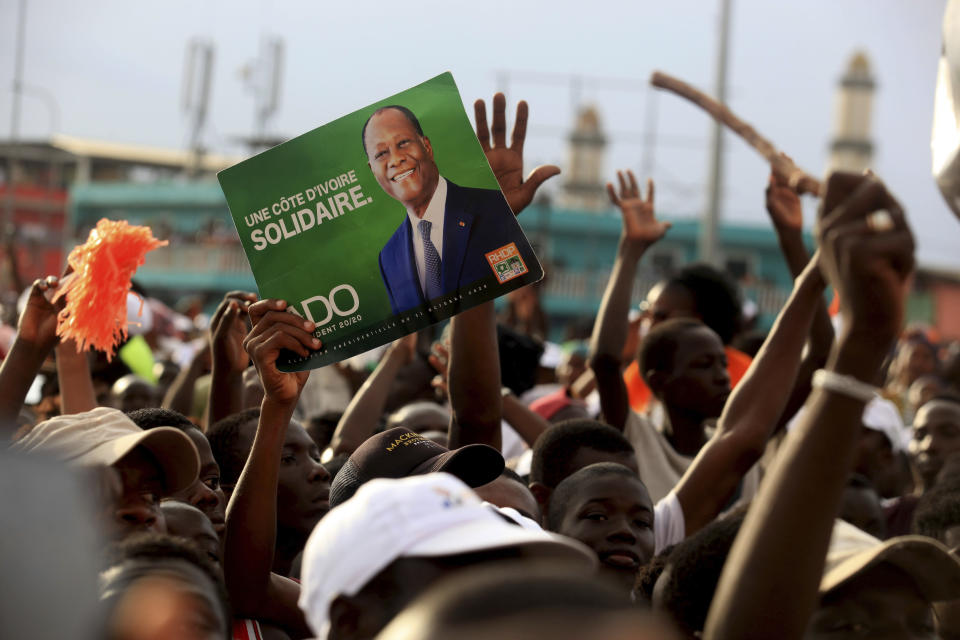 Supporters of President Alassane Ouattara cheers during his last rally in Abidjan, Ivory Coast, Thursday Oct. 29, 2020. Ouattara, who first came to power after the 2010 disputed election whose aftermath left more than 3,000 people dead, is now seeking a third term in office. Opposition candidate Henri Konan Bedie called for a boycott of the Oct. 31 election, complaining that the country's electoral commission is made up entirely of officials from the ruling party.(AP Photo/Diomande Ble Blonde)