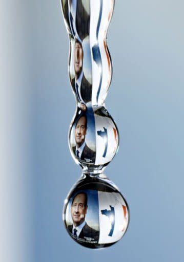 A drop of water reflects the campaign poster of newly elected president Francois Hollande and a map of France emblazoned with the colors of the French flag. Hollande was plunged straight into the European economic debate Monday as doubts over his plans and turmoil in Greece threatened to tip the eurozone back into crisis