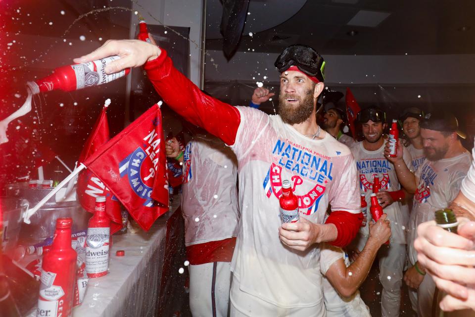 Bryce Harper celebrates in the clubhouse after the Phillies' Game 5 win.