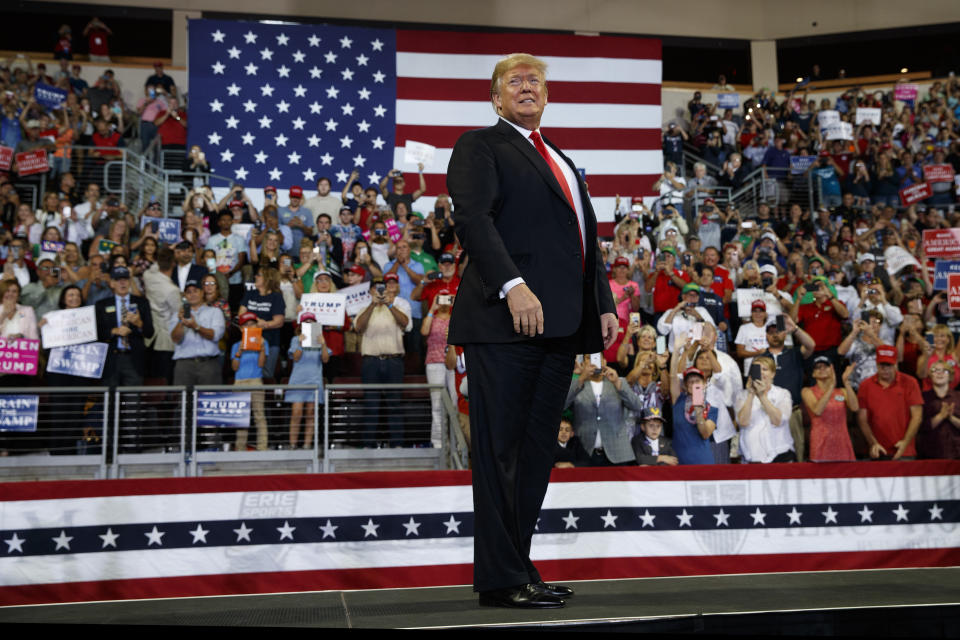 FILE - In this Oct. 10, 2018, file photo, President Donald Trump arrives to speak at a campaign rally at Erie Insurance Arena, in Erie, Pa. President Donald Trump's campaign rallies once had the feel of angry, raucous grievance sessions. More than 350 rallies later, gone is the darkness, the crackling energy, the fear of potential violence as supporters and protesters face off. Perish the thought, have Donald Trump's rallies gone mainstream? (AP Photo/Evan Vucci, File)