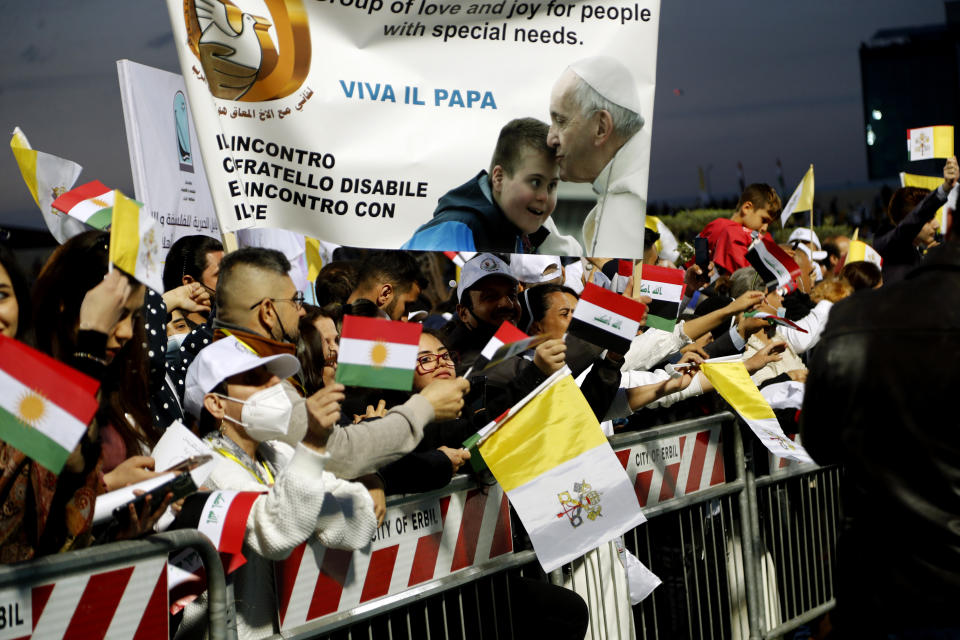 Iraqi Christians say goodbye to Pope Francis after an open air Mass at a stadium in Irbil, Iraq, Sunday, March 7, 2021. Thousands of people filled the sports stadium in the northern city of Irbil for Pope Francis' final event in his visit to Iraq: an open-air Mass featuring a statue of the Virgin Mary that was restored after Islamic militants chopped of the head and hands. (AP Photo/Hadi Mizban)