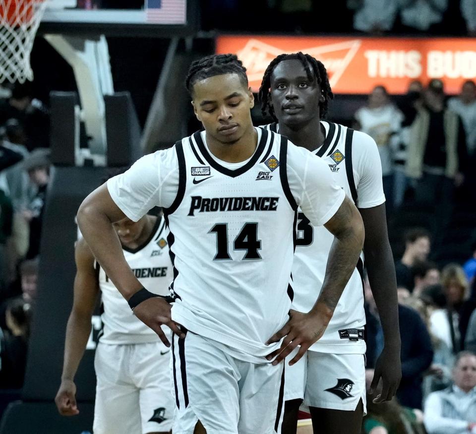 Friar guard Corey Floyd Jr. and Garwey Dual head off the court after the Friars fall to the Eagles 57-62 in the first round of the NIT.