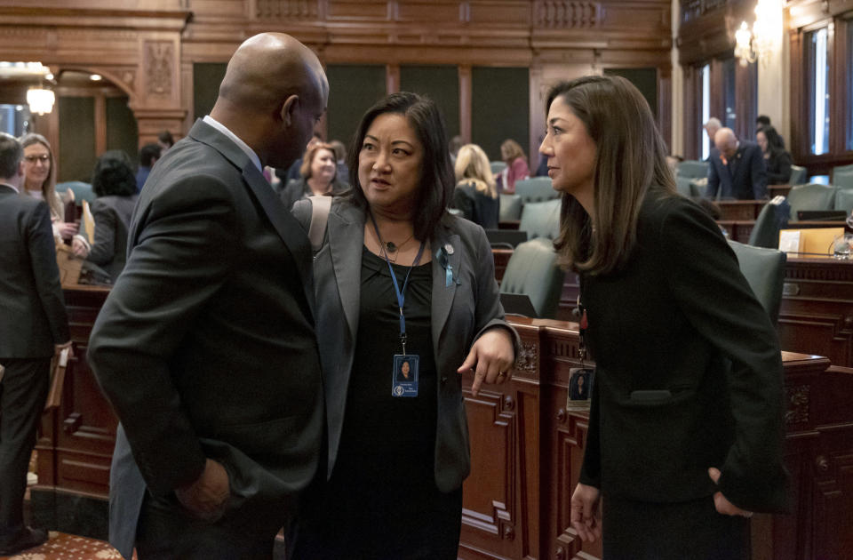 House Speaker Emanuel "Chris" Welch speaks to state Rep. Theresa Mah, center, and state Rep. Denyse Wang Stoneback after the passage of a gun bill banning assault weapons and high capacity magazines Tuesday, Jan. 10, 2023, at the Illinois State Capitol in Springfield, Ill. (Brian Cassella/Chicago Tribune via AP)