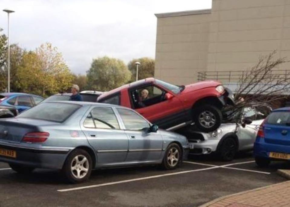 In a parking blunder, somehow this driver managed to run over a tree, Peugeot 206 and Mini before he realised his error in Rugby, Warks (SWNS)