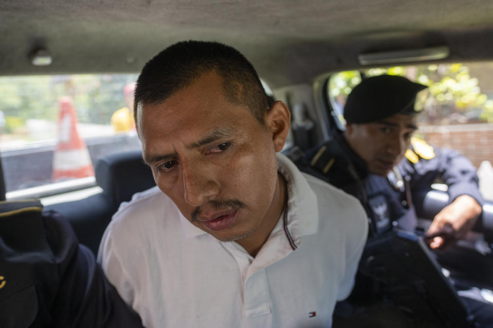 FILE - A detainee who identified himself as Felipe Diego Alonzo is escorted away from his property during a police raid against alleged migrant smugglers near the Mexican border in Huehuetenango, Guatemala, Tuesday, Aug. 2, 2022. Alonzo and three others were arrested at the request of the U.S. government, which is seeking their extradition. (AP Photo/Moises Castillo, File)