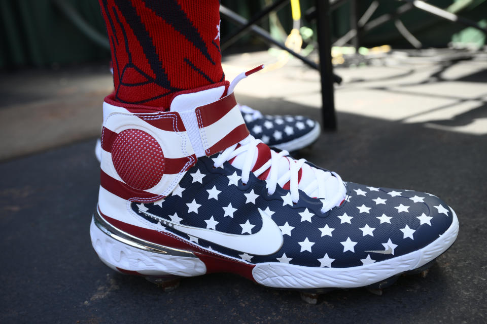 Washington Nationals' Nelson Cruz wears patriotic themed shoes before a baseball game against the Miami Marlins, Monday, July 4, 2022, in Washington. (AP Photo/Nick Wass)