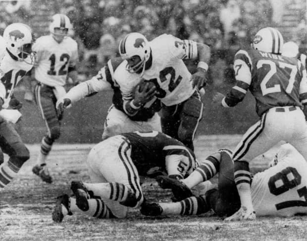 In this Dec. 16, 1973 file photo, O.J. Simpson of the Buffalo Bills runs against the New York Jets in the first quarter of an NFL football game at Shea Stadium in New York. Simpson became the first NFL player to rush for more than 2,000 yards in a season, surpassing that mark in this game. 