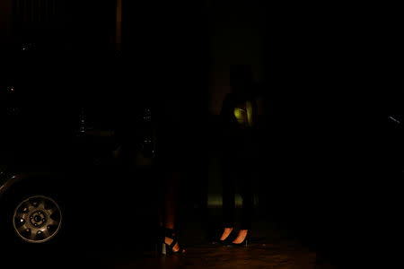 Women wait for their cars at a parking garage during a blackout in Caracas, Venezuela March 7, 2019. REUTERS/Carlos Garcia Rawlins